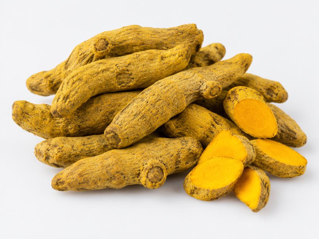 Dried whole turmeric fingers with golden-yellow cut pieces